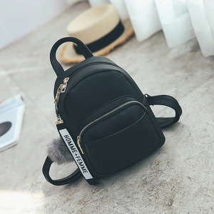 Mini black leather backpack with lychee texture and plush fur ball pendant detail
