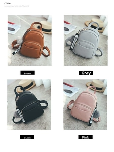 Detail view of mini PU leather backpacks in four colors with plush pompom and ribbon trim