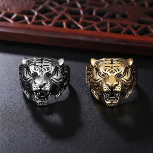 Men's titanium steel tiger head rings in gold and silver finish on a dark background