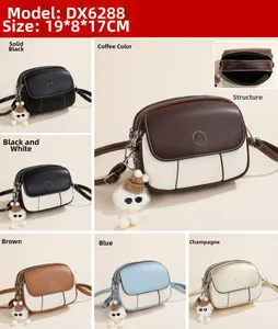 Detail view of stylish crossbody bags in various colors with plush ball charms and measurements