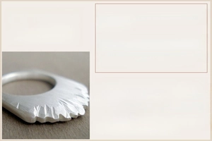 Macro detail of 925 sterling silver ring featuring artistic radial engraved patterns