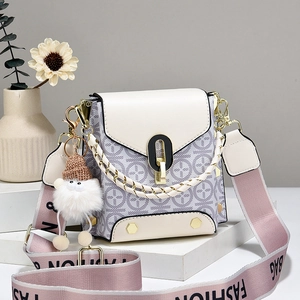 Chic cream and lavender printed crossbody bag with a wide strap and plush pendant