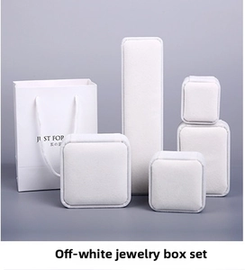 Detail of luxury off-white velvet jewelry box set with matching paper gift bag