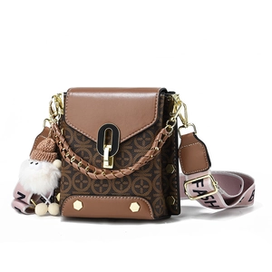 Vintage brown crossbody flap bag with monogram pattern and wide fabric strap