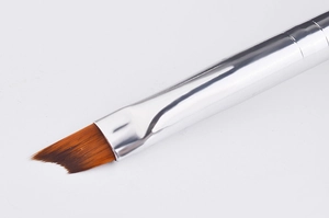 Close-up of professional angled nail art brush with brown bristles and silver ferrule
