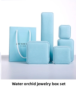Detailed set of light blue velvet jewelry boxes and matching gift bags for accessories