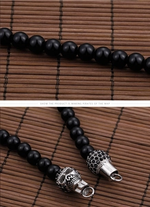 Macro shot of 316L stainless steel engraving on punk skull beaded necklace chain