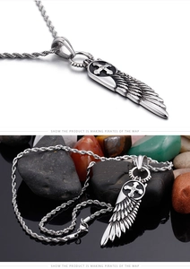 Macro shot of silver wing pendant with cross emblem on twisted rope chain necklace