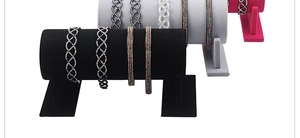 Detail showing multi-layer black velvet headband display stand with crystal headpieces