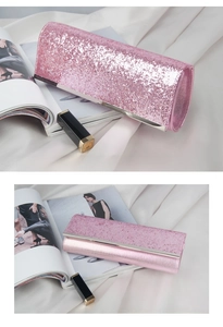Detailed close-up of pink sequin evening bag with metallic trim on white satin background