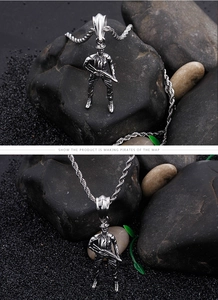 Detailed view of stainless steel soldier pendant with gun on dark stone texture