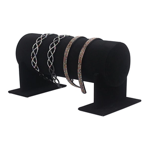 Set of four velvet-covered headbands with sparkling rhinestones on black display stands