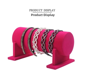 Detail showing five rhinestone headbands displayed on a velvet hair accessory stand