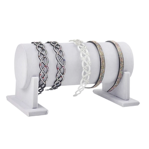 Gray cylinder headband display stand with elegant rhinestone and floral hair accessories