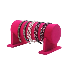 Hot pink velvet headband display stand with H-shaped base for organizing hair accessories