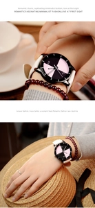 Detail of quartz watch with white leather strap and pink-black diagonal contrast dial