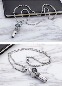 Close-up of silver stainless steel whistle pendant necklace with an integrated compass