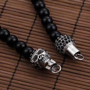 Men's punk skull bracelet with black beads and 316L stainless steel clasp detail