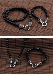 Detail of punk skull bracelet with black beads and vintage silver toggle clasp