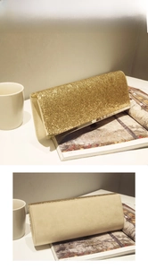 Detail of evening clutch featuring dense gold sequins and soft beige suede backing