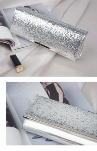 Macro detail of silver sequined evening clutch bag with elegant metallic trimming