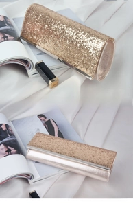 Detail of pink sequin evening bag with glitter surface and silver metal frame