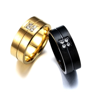 Close-up of titanium steel rings with brushed finish and four square-set zircons