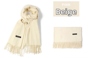 Detailed view of beige cashmere scarf featuring elegant long tassels and soft texture