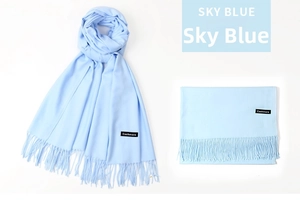 Detail of sky blue cashmere scarf showing fringe edges and authentic fabric label