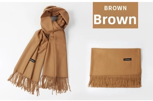 Macro shot of brown cashmere scarf texture showing fringe detail and premium soft fabric