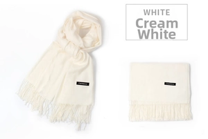 Detailed view of milk white cashmere scarf featuring soft texture and fine fringe tassels