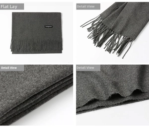 Detailed macro view of dark grey cashmere scarf fabric texture and long fringe tassels