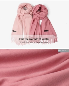 Close-up of pink cashmere scarves showing fine diagonal twill weave and fringe detail