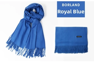 Detail of royal blue cashmere scarf texture with tassel fringe and material label