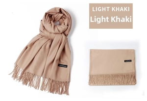 Detailed close-up of light khaki cashmere scarf featuring soft fringe edges and texture