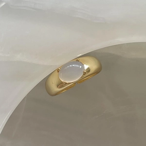925 silver open ring with gold finish and oval white crystal in a four-prong setting