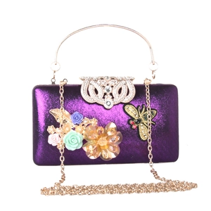 Detail of purple satin evening bag with 3D floral petals, bee embroidery and crystal buckle