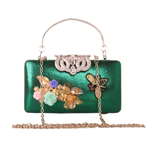 Detail of green metallic evening bag featuring 3D resin flowers and a gold jeweled insect
