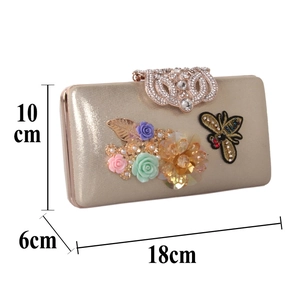 Detailed size view of golden evening clutch with 3D satin flowers and bee decoration