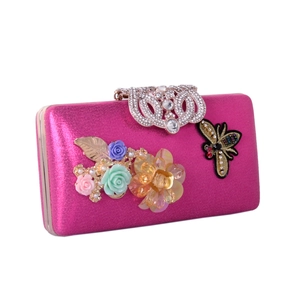 Detail of satin floral evening bag with crystal bee patch and jewel clasp in rose pink