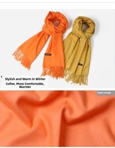 Macro detail of twill weave cashmere scarf fabric in bright orange and mustard yellow