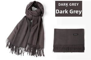 Detail of dark grey cashmere scarf with fringe edges and premium fabric texture label