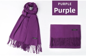Detail of purple cashmere scarf featuring long fringes and stitched brand wash label