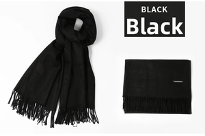 Detail of premium black cashmere scarf showing soft texture and fringe tassels