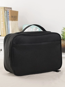 Close-up of black Oxford cloth lunch bag with wide handle and metal zipper details