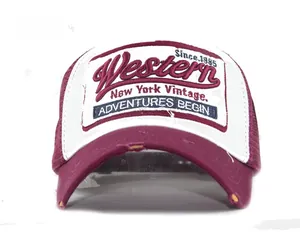 Close-up of vintage Western embroidery and distressed brim on the maroon trucker hat