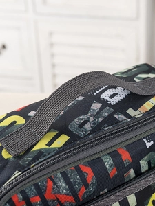 Close-up of durable zipper and reinforced handle on blue camouflage insulated lunch bag