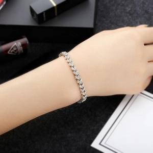 Exquisite silver-tone bracelet with pavé-set crystals worn on wrist for an elegant look