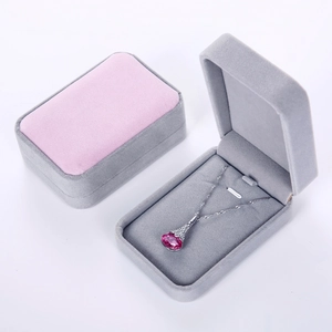 Close-up of velvet necklace gift boxes in pink and grey showing interior pendant holder