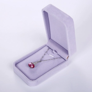 Detailed view of pink gemstone necklace in a luxury velvet rectangular jewelry gift box